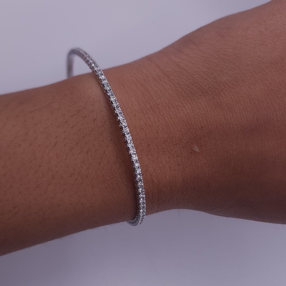 14 k w gold flexible bangle tennis bracelet w/over 3 carats of natural diamonds.